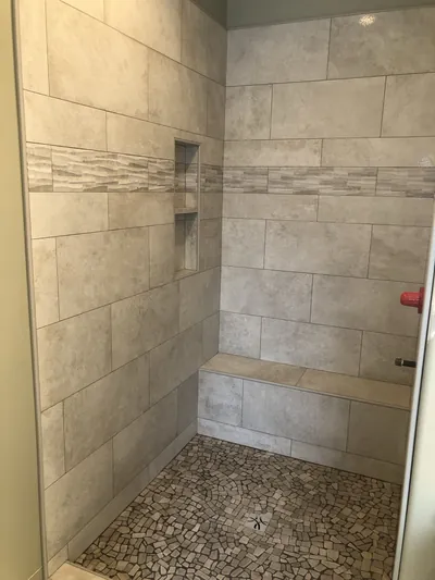 Custom Shower w/ Pebble Floor, Bench, Niche, and Feature Band Details 7