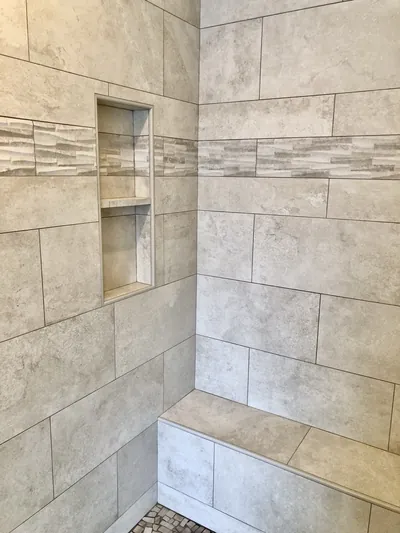 Custom Shower w/ Pebble Floor, Bench, Niche, and Feature Band Details 9