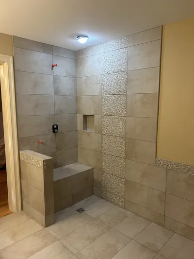 Custom Tile Shower w/ Bench, Pony Wall, Niche, and Feature Band Details 4
