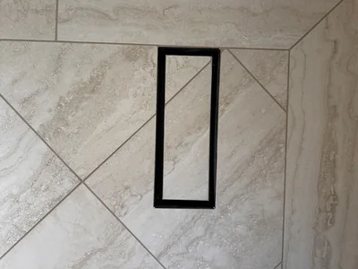 Flush-set floor vent tiled into a travertine-look floor