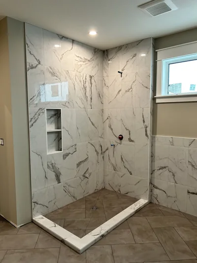 Custom tile shower with herringbone floor